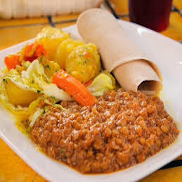 Ethiopian beef sauce with vegetable sauce and injera